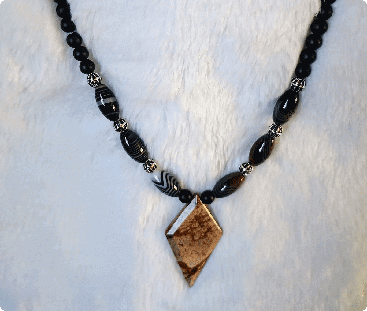 Black beaded necklace with a stone pendant.